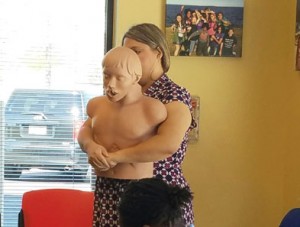 Staff practicing CPR skills on a CPR dummy